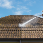 Pressure washing moss from a Sydney tile roof before repainting